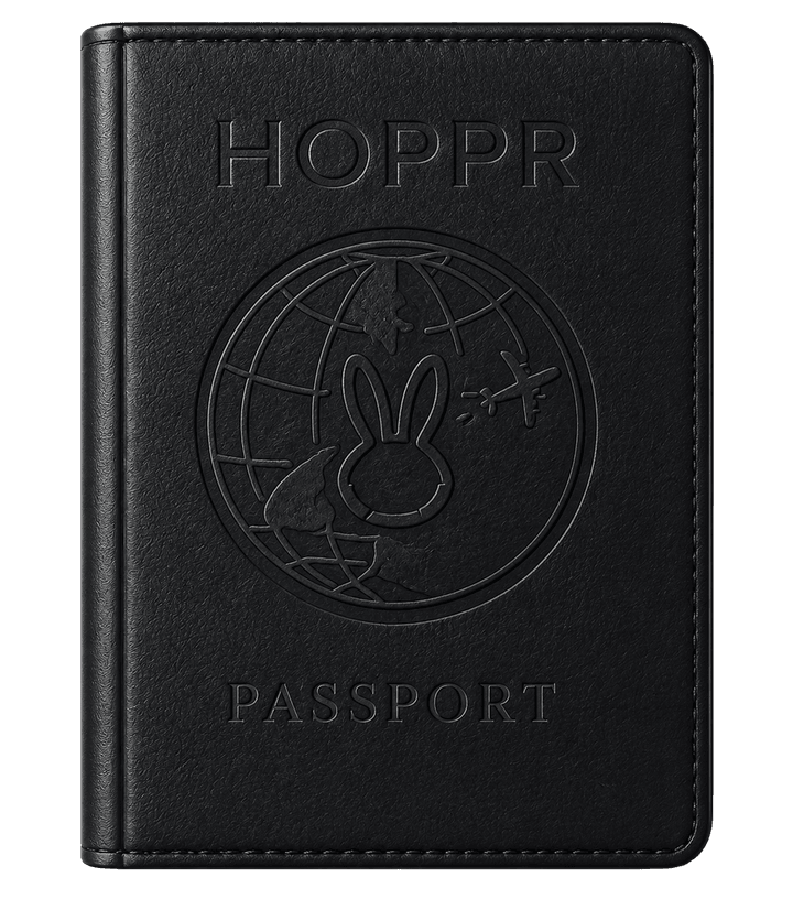 The Hoppr passport: a black book embossed with a bunny inside a globe